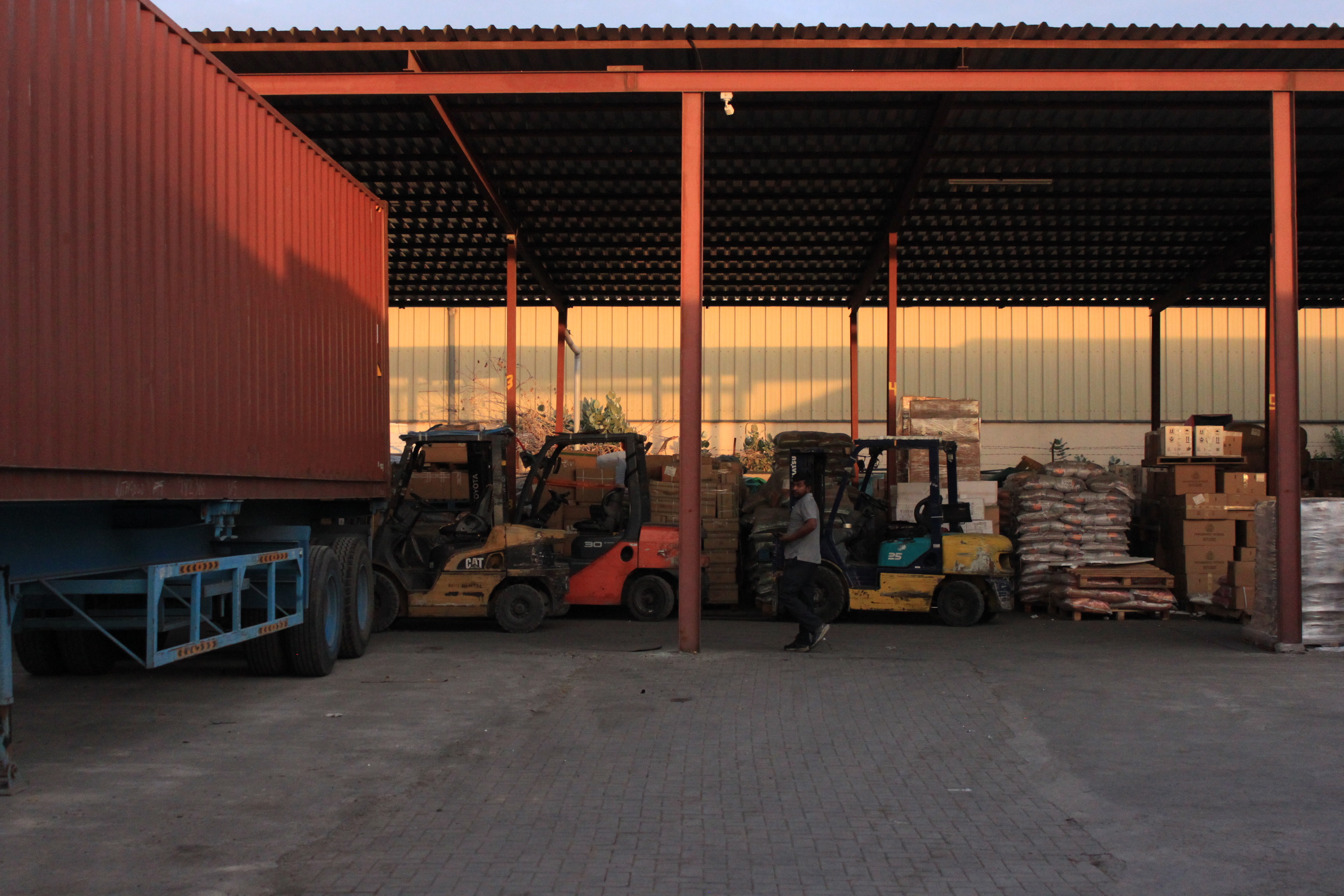 Photographs of spacious and well-organized warehouses used by Model Cargo Moovers ability to handle diverse shipping needs.Card image cap